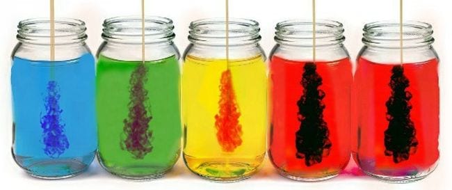 Rainbow colored jars with rock candy sticks in each